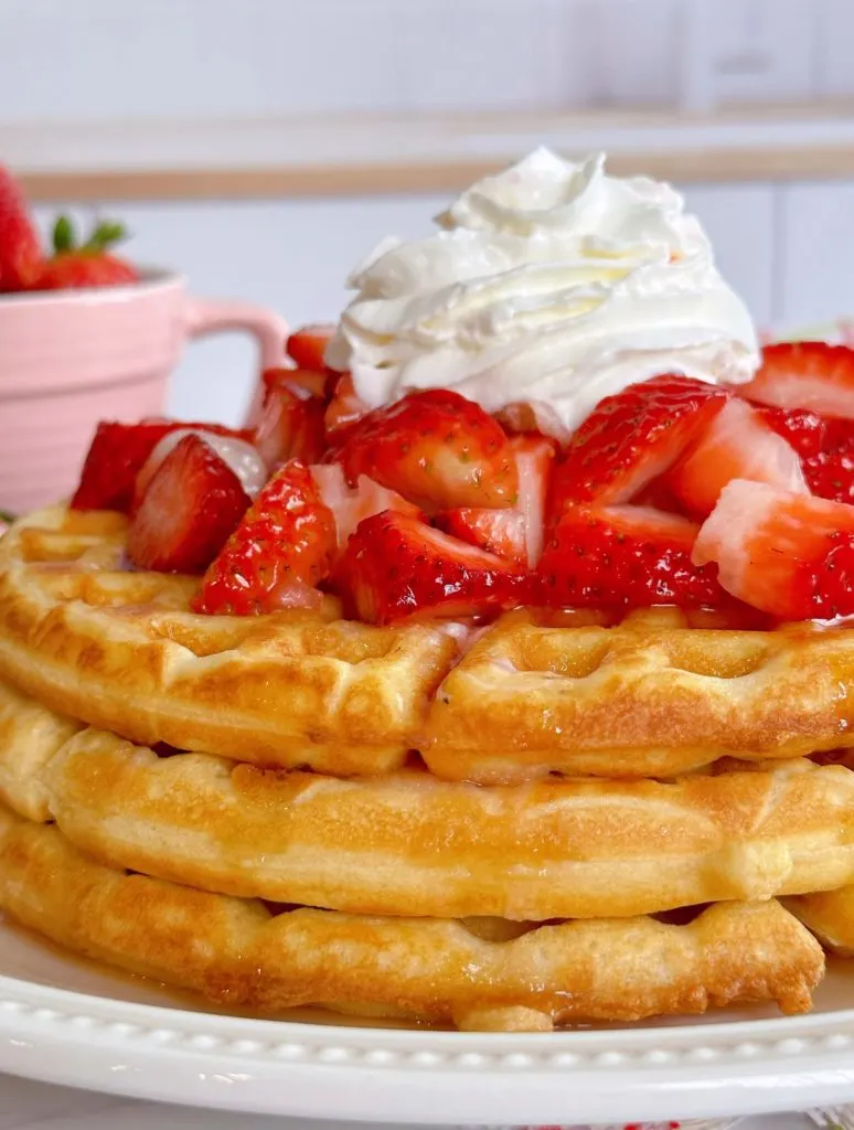 Close-up of stack of waffles with fresh Strawberries.