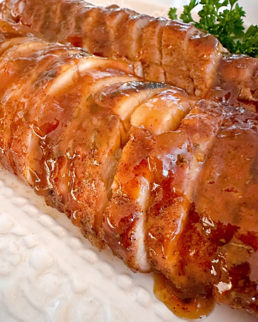 Brushed glaze on the pork tenderloin and sliced ready to eat.