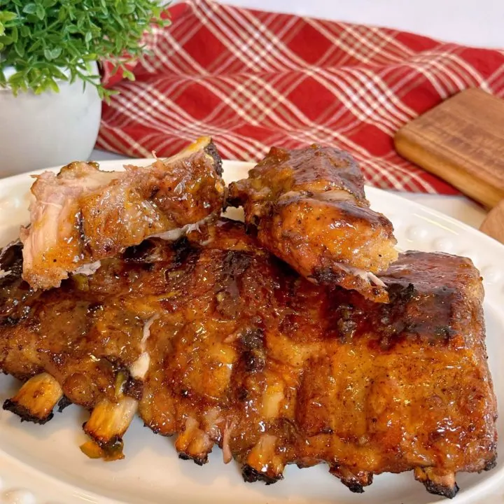 Perfect Grilled Baby Back Pork Ribs slathered in Special Glaze on a white serving dish.