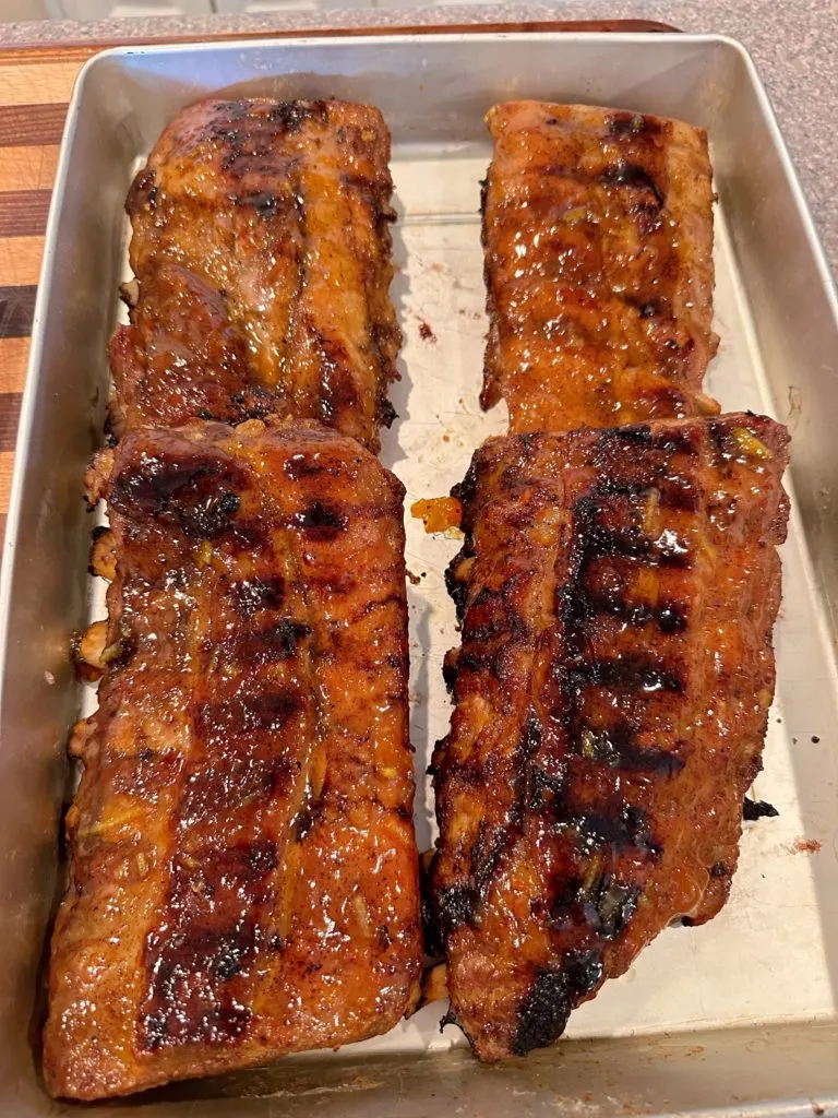 Ribs in a baking pan after grilling.