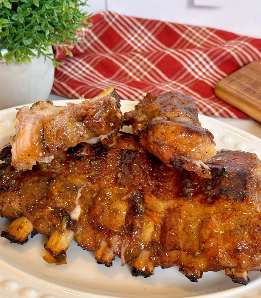 Baby Back Pork Ribs with Special Apricot Glaze on a white platter. 