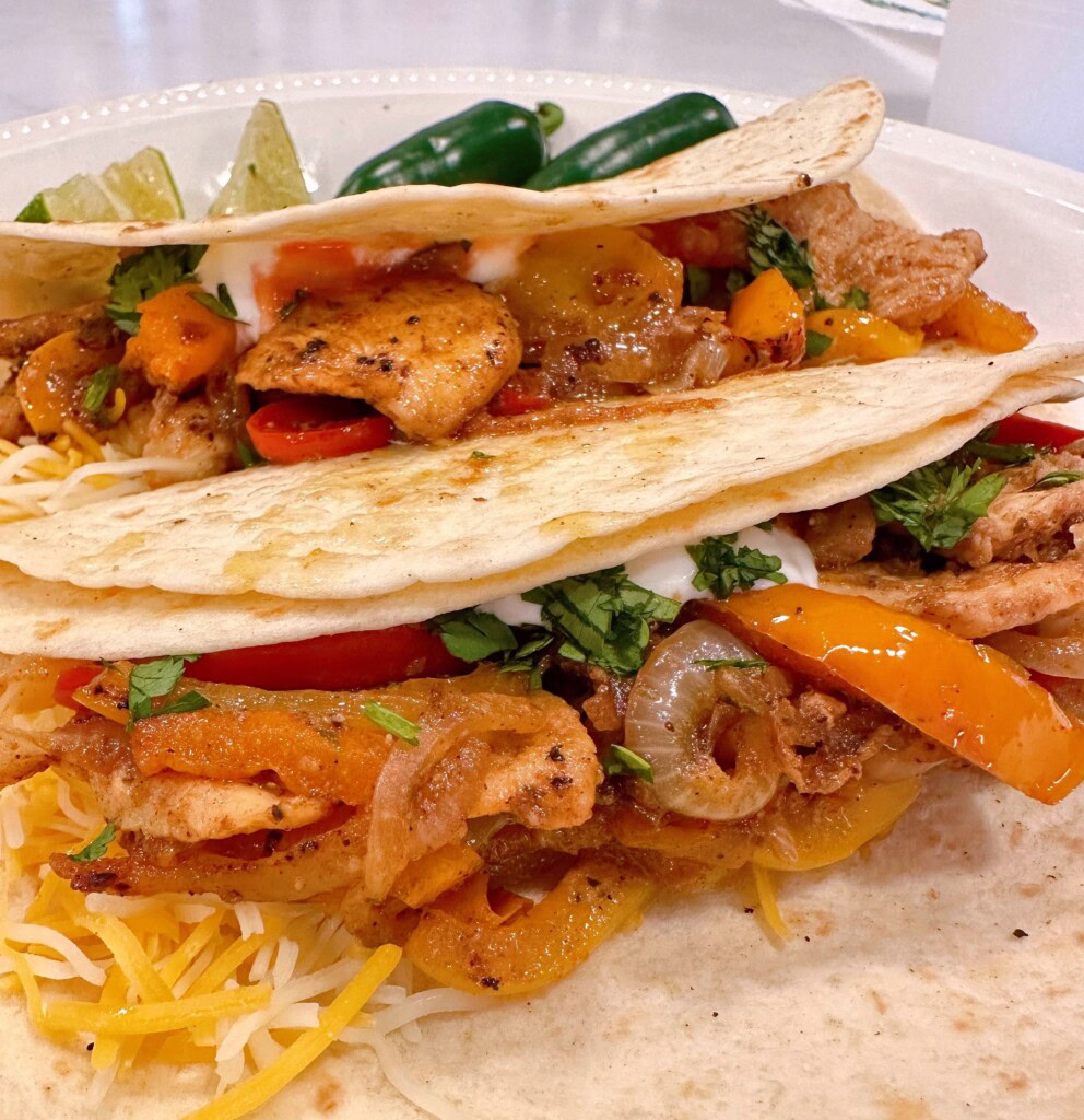 Tangy Chicken Fajitas on a plate with all the fillings.