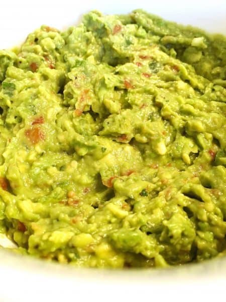 Avocado mixed together with seasonings, salsa, and spices to create the BEST Homemade Guacamole.