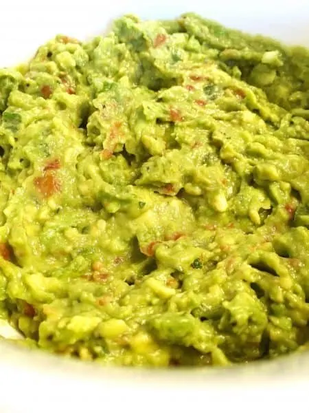 Avocado mixed together with seasonings, salsa, and spices to create the BEST Homemade Guacamole.