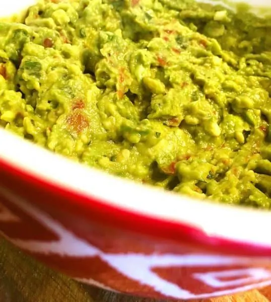 Homemade Guacamole in a beautiful red bowl waiting for chips!