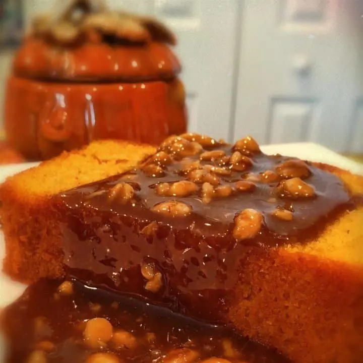 Slice of Pumpkin Pound cake with Walnut Caramel Sauce on a dessert plate.