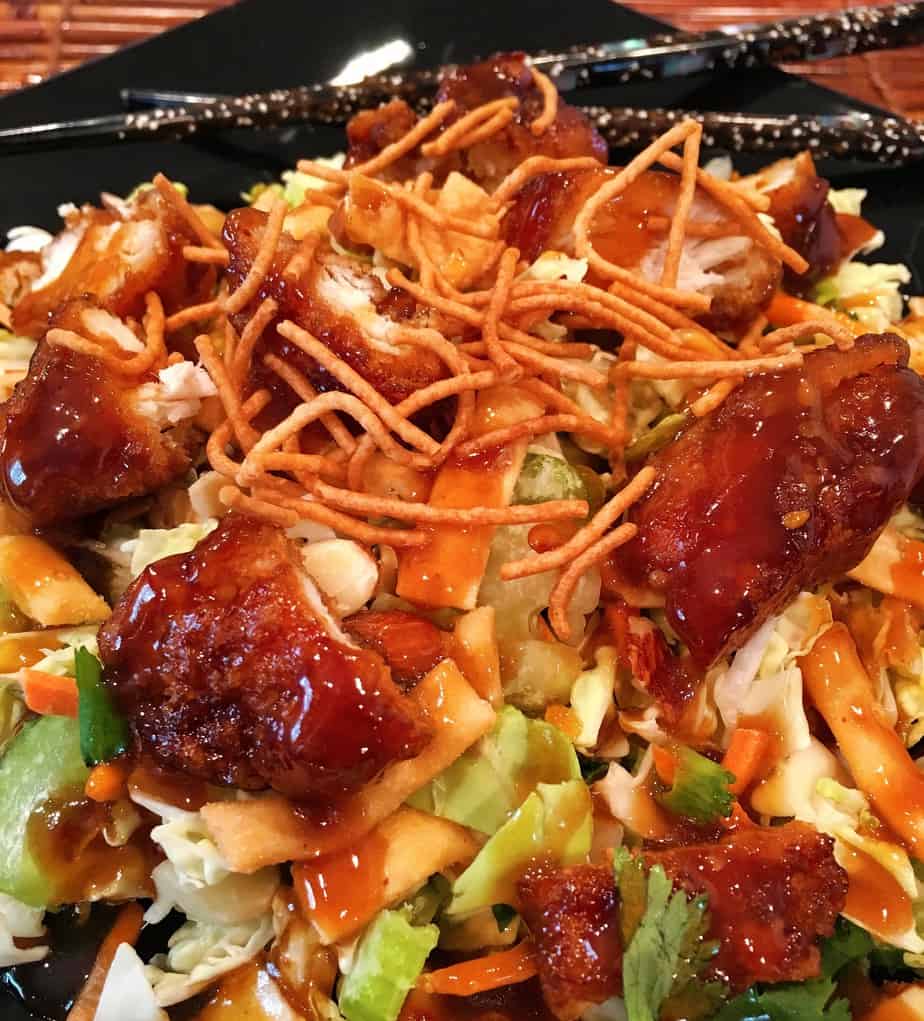 Salad with chicken, vegetables, dried noodles, and an asian sauce