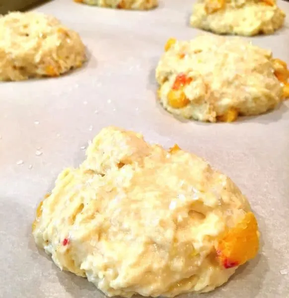 Peach scone dough on baking pan with silicone mat.