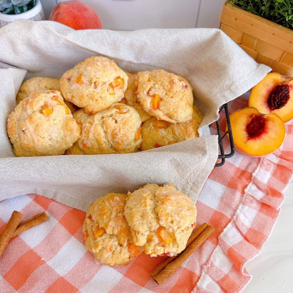 Peaches and cream scones in a basket on a table.