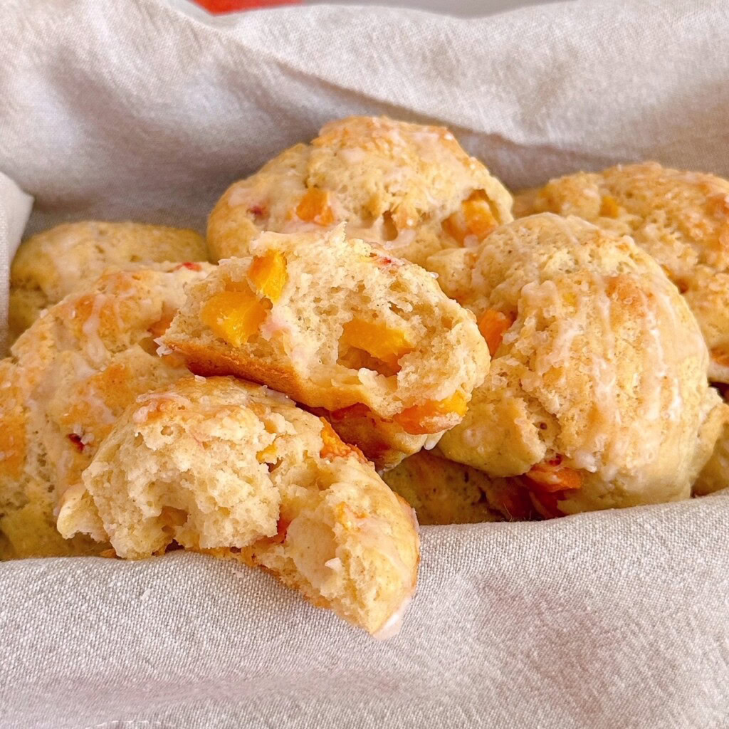 Peach scones in a basket with one broken open.