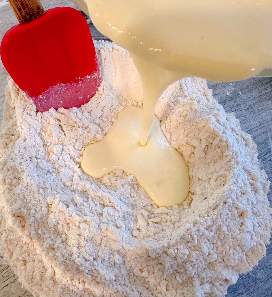 Adding wet ingredients to the dry ingredients.