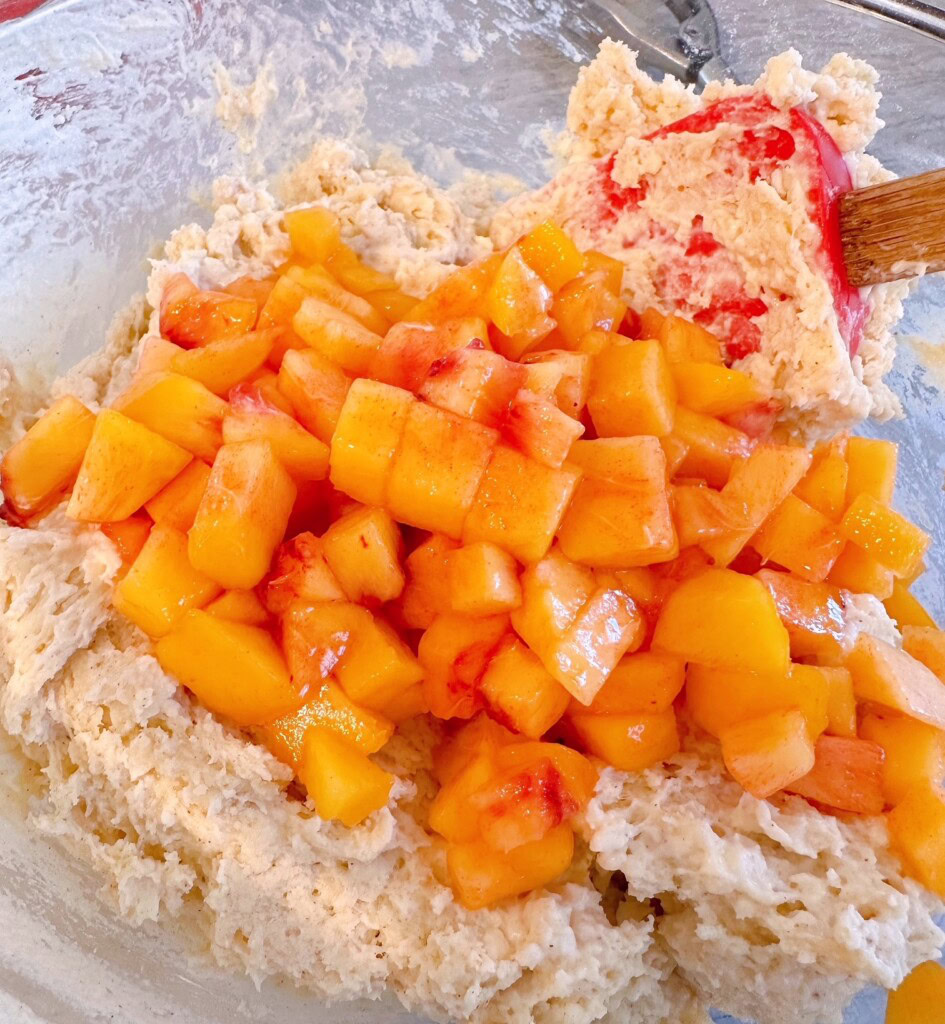 Adding peaches to the scone dough.