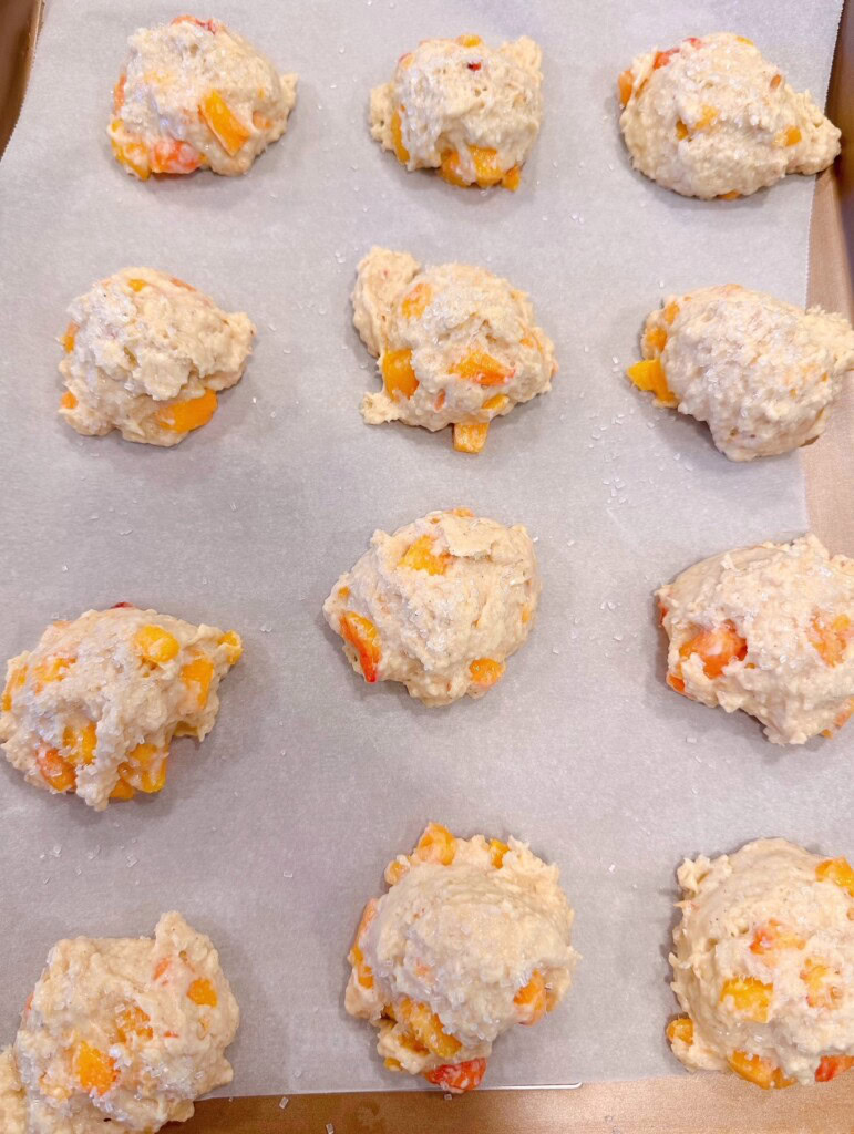 Peach Scones dropped onto a lined baking sheet.