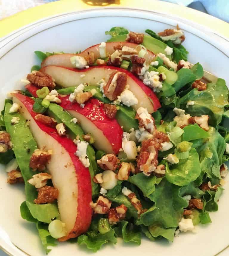 Pear and blue cheese salad with nuts on a plate.