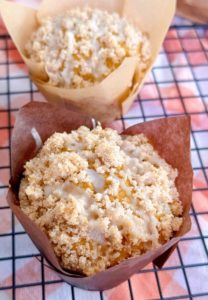 Close-up of Pumpkin Streusel Muffin in a baking liner on a cooling rack.