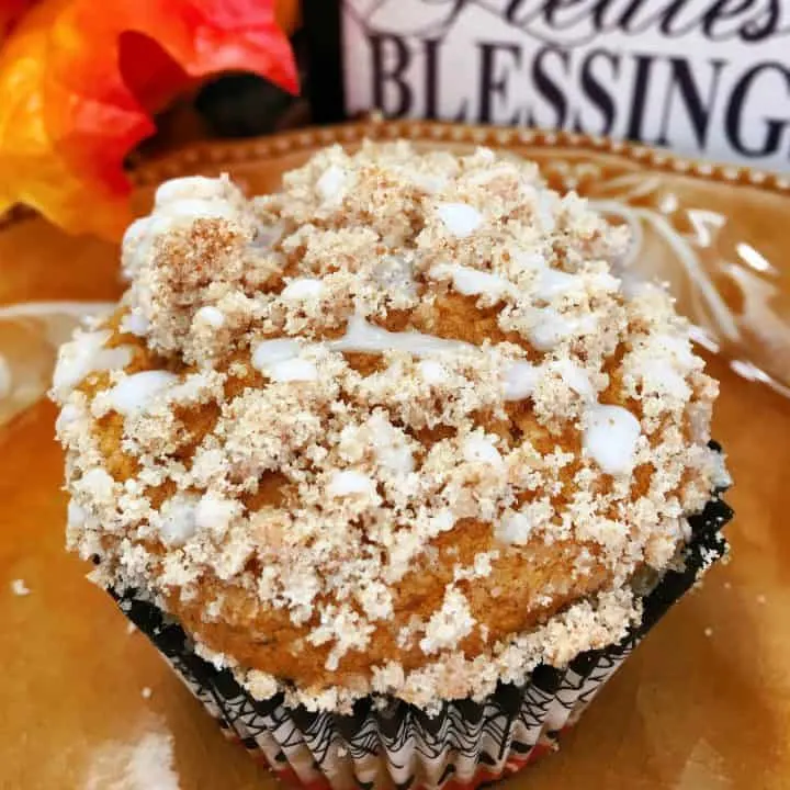 Pumpkin Struesel Muffins on a plate with fall decor.