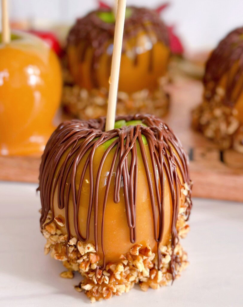 Chocolate and nut dipped caramel apple up close.