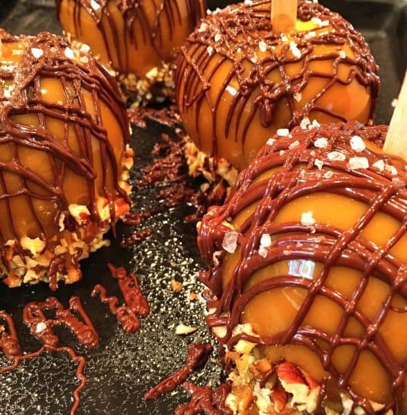 Granny smith apple dipped in caramel twice and drizzled with chocolate and nuts