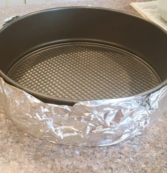 spring form pan wrapped in foil for water bath