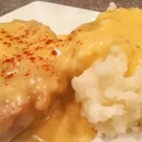 Pork chops cooked in a crock pot and chicken fried with gravy