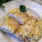 Chicken Fried Pork Chops in the Slow Cooker served over a plate of mashed potatoes.