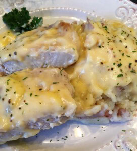 Chicken Fried Pork Cho9ps on a bed of homemade mashed potatoes.