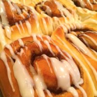 Large cinnamon rolls drizzled with white frosting