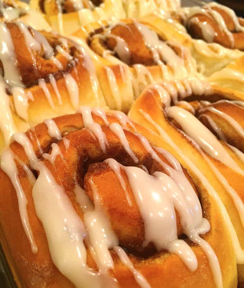 Large cinnamon rolls drizzled with white frosting