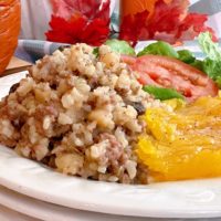 Dinner in a pumpkin on a dinner plate with the squash.