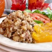 Dinner in a pumpkin on a dinner plate with the squash.