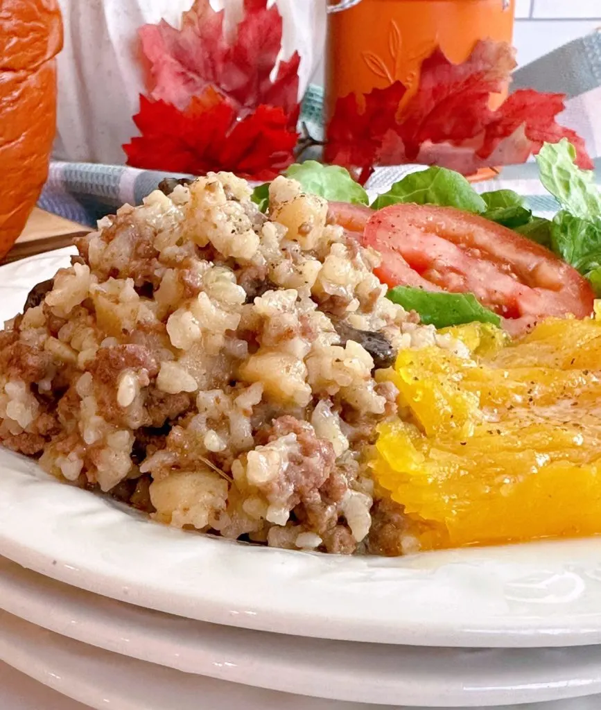 Dinner in a pumpkin on a dinner plate with the squash.