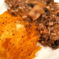 A pumpkin filled with ground beef, seasonings and rice