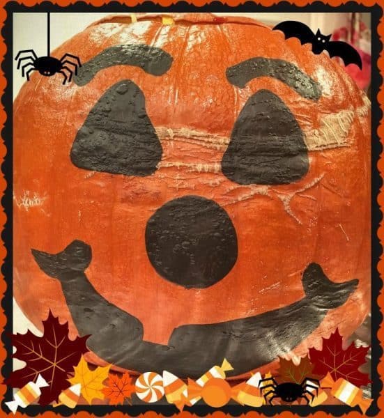 Big baked stuffed pumpkin with jack-o-latternface for dinner in a pumpkin