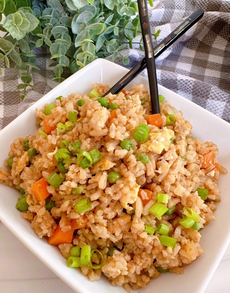 Fried Rice in a white square serving dish with chop sticks.