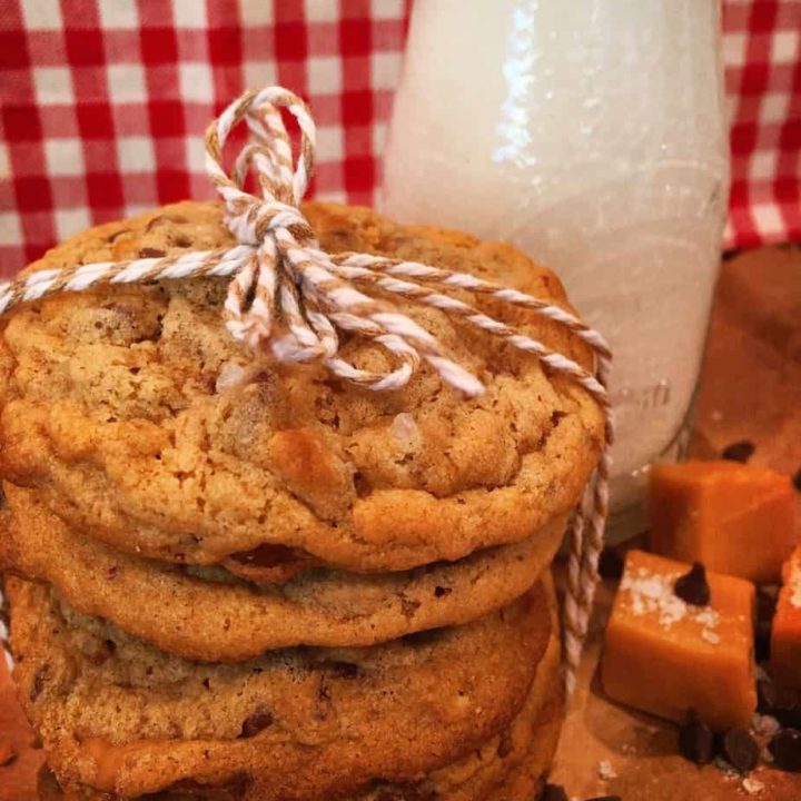 Stack of Salted Caramel Cookies tied with string and salted caramels around the base.