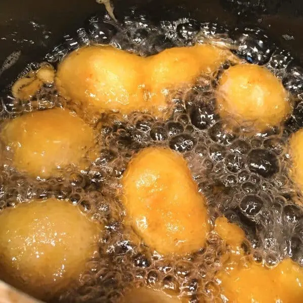 sweet and sour chicken frying in hot oil