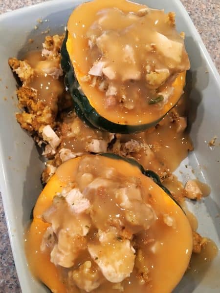Stuffed Acorn Squash with gravy poured over the top before baking