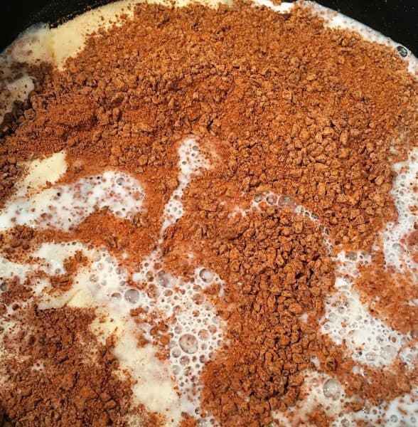 chocolate bits in milk melting in sauce pan