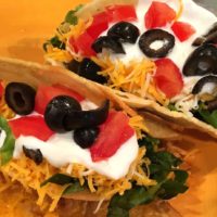 chicken shredded and cooked in a crook pot. Seasoned with mexican spices. Served in taco shells with tomato, olives, cheese and lettuce