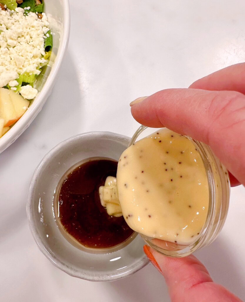 Salad dressings in bowls combining.