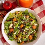 Salad and dressing combined and in a salad bowl.