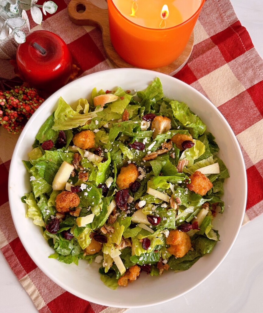 Salad and dressing combined and in a salad bowl.