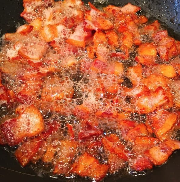 Bacon cooking in skillet.