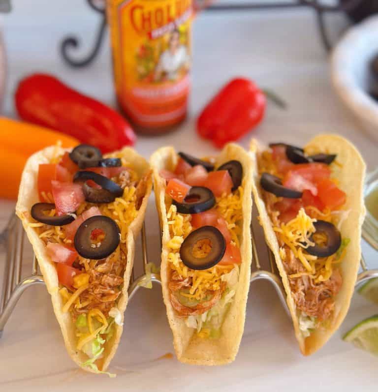 Slow Cooker Chicken tacos in a taco holder.