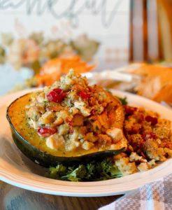 Stuffed Acorn Squash on a plate and festive Fall table setting.