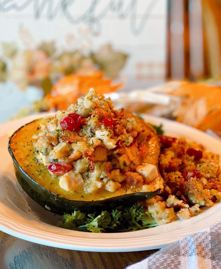 Stuffed Acorn Squash on a plate and festive Fall table setting.