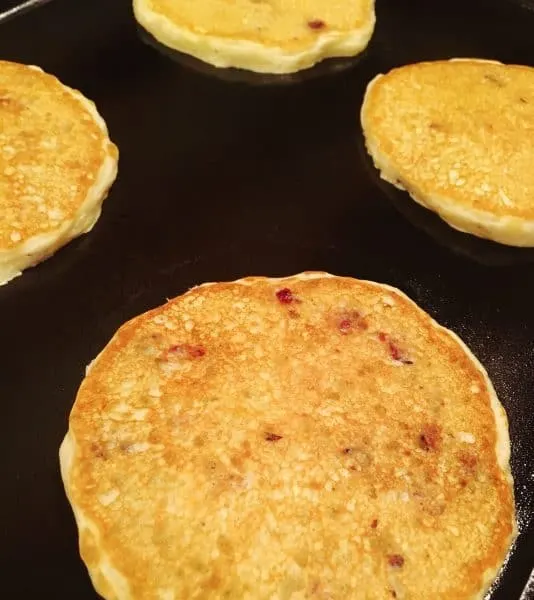 Cranberry Orange Pancakes flipped over on the grilled