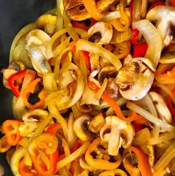 Sauteed peppers, onions, and mushrooms in skillet