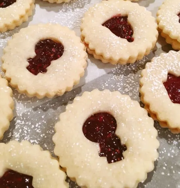 Linzer cookies filled and ready to dust with powder sugar