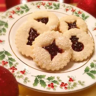 Linzer Raspberry filled cookies on a holiday plate.